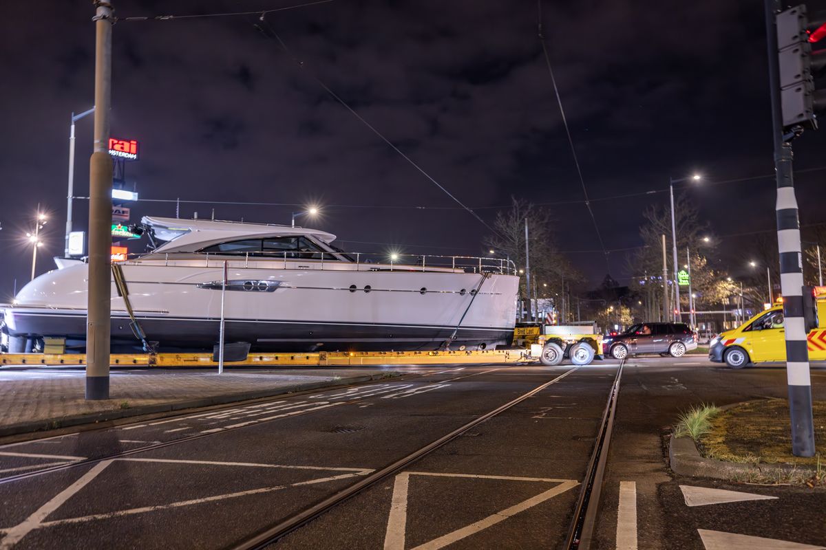 Yacht through nightly Amsterdam